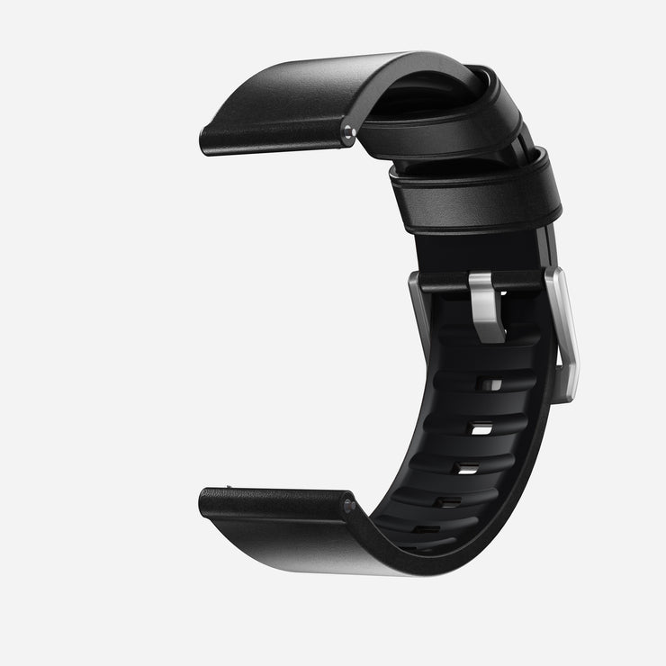 The Nomad Active Band Pro - 22mm Quick Release in Black Horween leather with silver hardware is shown open and angled against a white background; compatible as a 22mm smartwatch strap.