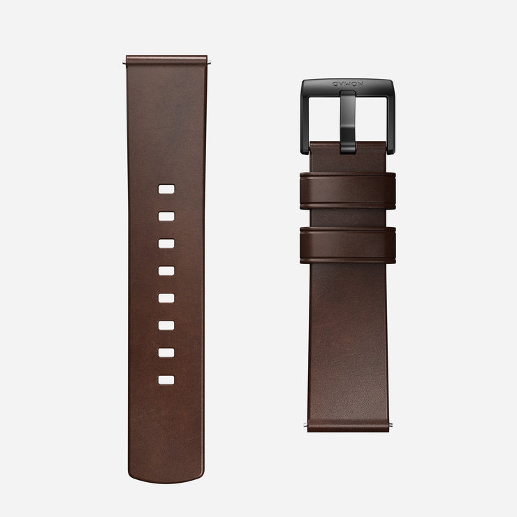 Two pieces of the Nomad Active Band Pro - 22mm Quick Release in Brown Horween leather with black hardware are displayed side by side. One strap has adjustment holes, while the other has the buckle and loops.