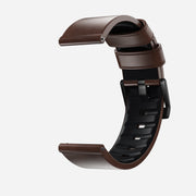 The Nomad Active Band Pro - 22mm Quick Release in brown Horween leather with black hardware is displayed in a semi-curved position against a white background.