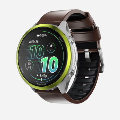 The Nomad Active Band Pro features a 22mm quick release brown Horween leather strap with silver hardware, pairing stylishly with Garmin smartwatches that display time, date, steps, battery level, heart rate, and activity icons.