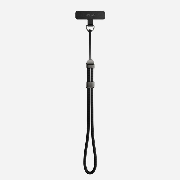 The Nomad Wrist Strap - Kevlar | Carbide is a black adjustable wrist lanyard with Kevlar reinforcement and a small rectangular attachment, designed for securing portable devices.