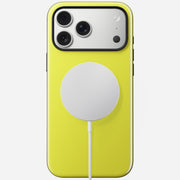 A Nomad Modern Case in Volt yellow is shown on an iPhone 17 Pro Max with three rear cameras, a white circular MagSafe charger attached, and a TPU bumper, all displayed against a plain white background.