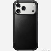 The Nomad Rugged Leather Case in Black for iPhone 17 Pro Max (Horween) is shown facing up, revealing the camera lenses and upper back. "After 100 Days" appears at the bottom right. The MagSafe-compatible case is sleek and protective.