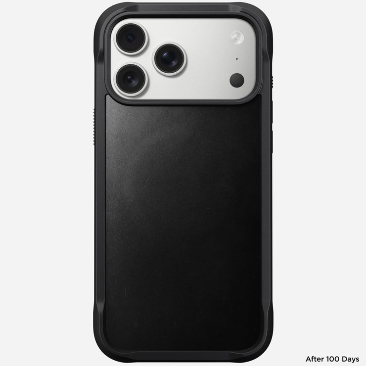 The Nomad Rugged Leather Case in Black for iPhone 17 Pro Max (Horween) is shown facing up, revealing the camera lenses and upper back. "After 100 Days" appears at the bottom right. The MagSafe-compatible case is sleek and protective.