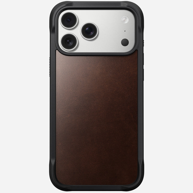 The Nomad Rugged Leather Case for iPhone 17 Pro Max in Rustic Brown features a black frame, premium Horween leather back, MagSafe compatibility, and precise cutouts for the phone's triple cameras and flash in the top left corner.