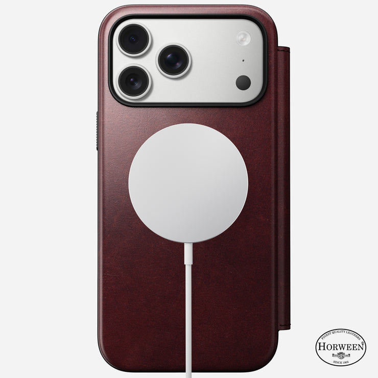 A Nomad Modern Leather Folio for iPhone 17 Pro Max in Burgundy Horween leather features MagSafe, three camera lenses, a Horween logo on the bottom right, and has a wireless charging pad attached to the back.