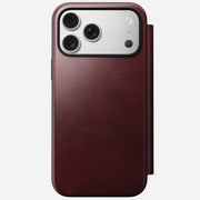 The Nomad Modern Leather Folio for iPhone 17 Pro Max in Burgundy Horween leather is shown from the back, displaying a smartphone with a triple camera setup against a plain white background.