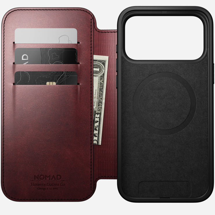 The Nomad Modern Leather Folio for iPhone 17 Pro Max in Burgundy features premium Horween leather, three card slots for cards and cash on the left, and a black MagSafe-compatible phone holder on the right.