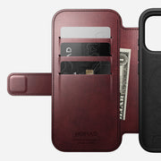 The Modern Leather Folio for iPhone 17 Pro by Nomad is crafted from burgundy Horween leather, features three card slots, holds two cards and cash, has "NOMAD Horween Leather Co. Chicago, IL 1905" embossed inside, and is MagSafe compatible.