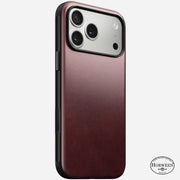 The Nomad Modern Leather Case for iPhone 17 Pro Max, shown in burgundy Horween leather with black edges, features a triple-camera cutout and the Horween logo at the lower right. This case is MagSafe compatible.