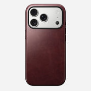 The Nomad Modern Leather Case for iPhone 17 Pro in burgundy Horween leather features MagSafe support and a silver camera module with three lenses and a flash in the top left corner.