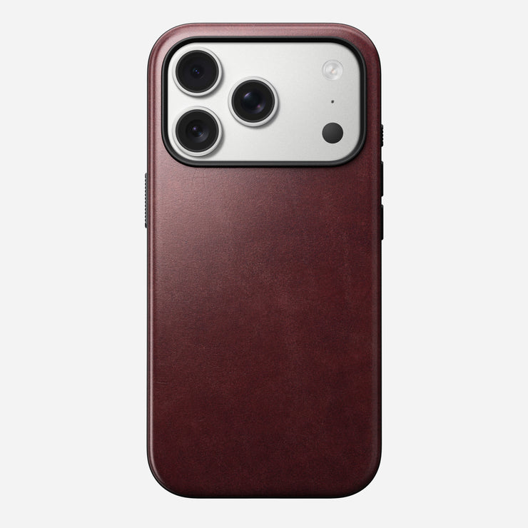 The Nomad Modern Leather Case for iPhone 17 Pro in burgundy Horween leather features MagSafe support and a silver camera module with three lenses and a flash in the top left corner.