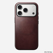 A Nomad Modern Leather Case in Burgundy Horween leather is shown on an iPhone 17 Pro, highlighting the triple camera and flash. "After 100 Days" appears in the bottom right corner.
