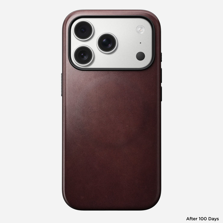 A Nomad Modern Leather Case in Burgundy Horween leather is shown on an iPhone 17 Pro, highlighting the triple camera and flash. "After 100 Days" appears in the bottom right corner.