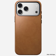 An iPhone 17 Pro Max in a Nomad Traditional Leather Case, English Tan, shows light wear and subtle scratches after 100 days of use. The camera module stands out at the top. White background with “After 100 Days” in the bottom right corner.