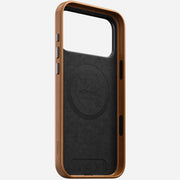 The Nomad Traditional Leather Case for iPhone 17 Pro Max in English Tan features full-grain leather, open front, side button cutouts, and a MagSafe-compatible interior labeled NOMAD, shown upright on a white background.