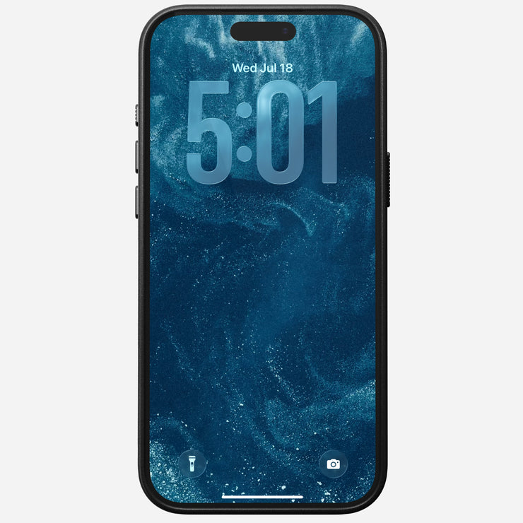 An iPhone 17 Pro Max with a black Nomad Traditional Leather Case displays a blue, swirling abstract lock screen showing 5:01 and Wed, Jul 18. Flashlight and camera icons are visible at the bottom. The case is MagSafe compatible.