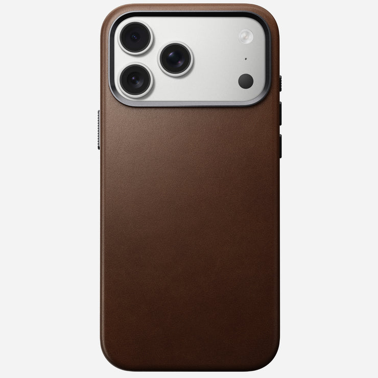 The Nomad Traditional Leather Case for iPhone 17 Pro Max in brown features full-grain leather, a triple camera cutout with flash in the top left corner, and MagSafe compatibility, shown against a white background.