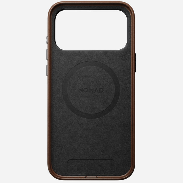 The Nomad Traditional Leather Case for iPhone 17 Pro Max in brown features full-grain leather, a large rectangular camera cutout, side button covers, and NOMAD centered within a circular design on the back.