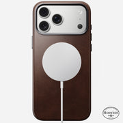 A Nomad Traditional Leather Case for iPhone 17 Pro Max in Rustic Brown Horween leather with MagSafe attached. The Horween logo appears in the lower right corner, and the triple camera is visible at the top.