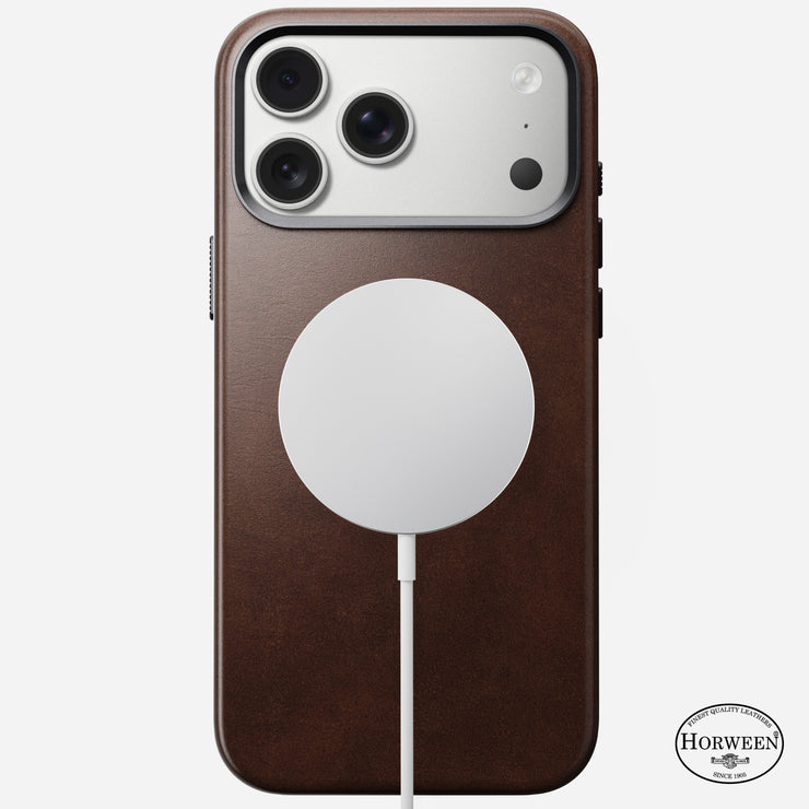 A Nomad Traditional Leather Case for iPhone 17 Pro Max in Rustic Brown Horween leather with MagSafe attached. The Horween logo appears in the lower right corner, and the triple camera is visible at the top.