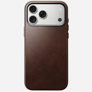 The Nomad Traditional Leather Case for iPhone 17 Pro Max in Rustic Brown Horween leather is shown MagSafe-compatible, on a white background with the phone’s triple camera and flash visible.