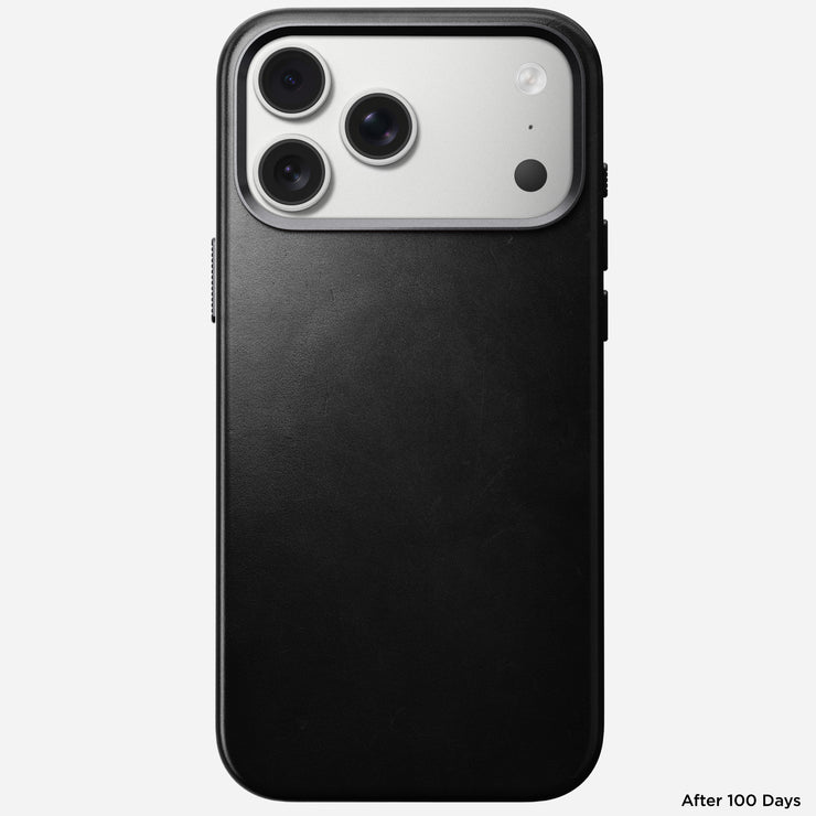 A Nomad Traditional Leather Case in black Horween leather is shown on the iPhone 17 Pro Max, highlighting its triple camera system. The words "After 100 Days" appear in small font at the bottom right corner.