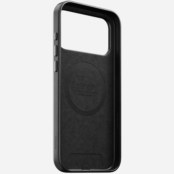 The Nomad Traditional Leather Case for iPhone 17 Pro Max features black Horween leather, a large camera cutout, MagSafe compatibility for easy wireless charging, and an interior embossed with the NOMAD logo. Shown upright on a light gray background.