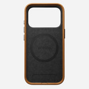 The Nomad Traditional Leather Case for iPhone 17 Pro in English Tan features a sustainably sourced full-grain leather frame, black back, and “NOMAD” branding at the center, shown on a plain white background. MagSafe-compatible.