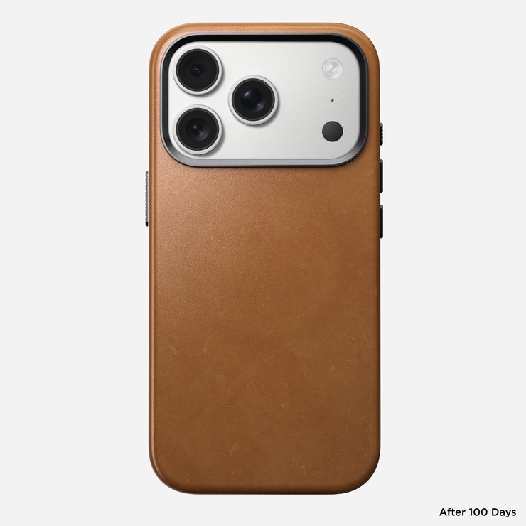 A Nomad Traditional Leather Case in English Tan – C, shown on an iPhone 17 Pro after 100 days of use. The full-grain leather displays a worn patina. The phone’s camera module has three lenses and a flash. Text: “After 100 Days.”.