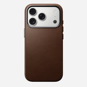 The Nomad Traditional Leather Case for iPhone 17 Pro in brown, shown on a phone with a triple-lens camera and flash, appears against a plain white background.