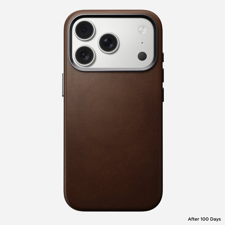 The Nomad Traditional Leather Case for iPhone 17 Pro in brown full-grain leather is shown from the back, featuring a triple camera cutout and smooth finish. "After 100 Days" appears in small text at the bottom right corner.