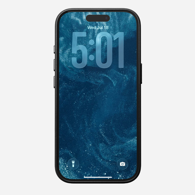 A smartphone in a Nomad Traditional Leather Case for iPhone 17 Pro (Black) displays 5:01 and Wed, Jul 18 on a blue abstract wallpaper; flashlight and camera icons show at the lock screen bottom.