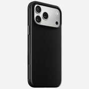 The Nomad Modern Case for iPhone 17 Pro Max in Vulcan Black features a matte finish, a silver triple-lens camera module with flash in the top corner, and a TPU bumper for enhanced grip and style.