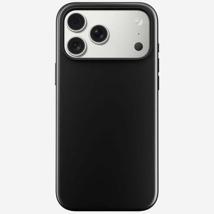 The Nomad Modern Case in Vulcan Black for iPhone 17 Pro Max is shown from the back, highlighting the silver triple-lens camera and flash. It features a durable TPU bumper and supports MagSafe charging, displayed on a light gray background.