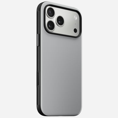 The Nomad Modern Case for iPhone 17 Pro Max in Lunar Gray showcases a sleek, minimalist silver and black look, with MagSafe compatibility, three rear cameras, and a flash in the top left corner—displayed at an angle on a white background.