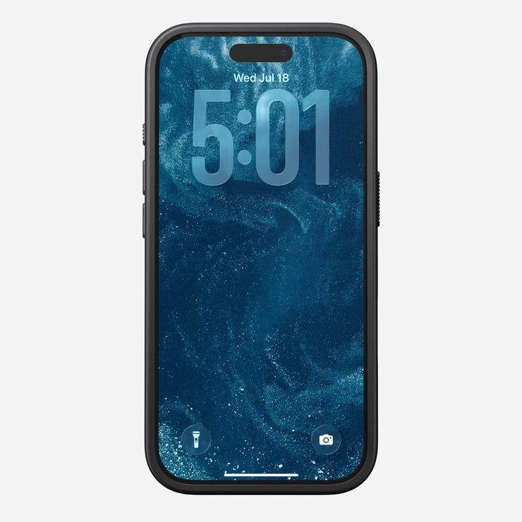 The Nomad Modern Case - iPhone 17 Pro in Vulcan Black showcases a phone with a blue marbled wallpaper, MagSafe compatibility, displaying 5:01 and Wed, Jul 18. Flashlight and camera icons are on the lock screen’s bottom.