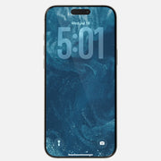 The Nomad Screen Protector for iPhone 17 Pro Max covers a lock screen displaying 5:01, Wed, Jul 18 with a blue abstract wallpaper. Made from durable Corning Ion-exchanged aluminosilicate glass, it’s scratch-resistant. Flashlight and camera icons are at the bottom.