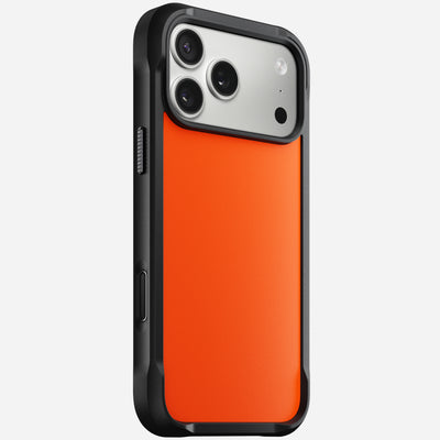 The Nomad Rugged Case in Ultra Orange for iPhone 17 Pro Max, featuring black and orange TPU bumpers, fits a phone with three rear cameras and a flash, displayed from an angled rear view on a plain white background.