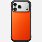 The Nomad Rugged Case - iPhone 17 Pro Max | Ultra Orange is a black and orange case with TPU bumpers, shown on the device’s back featuring three camera lenses and a flash in the top left corner.