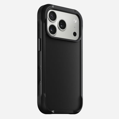 The Nomad Rugged Case - iPhone 17 Pro | Black features a rugged design with TPU bumpers, displayed on an iPhone 17 Pro with three camera lenses and a flash against a plain white background.