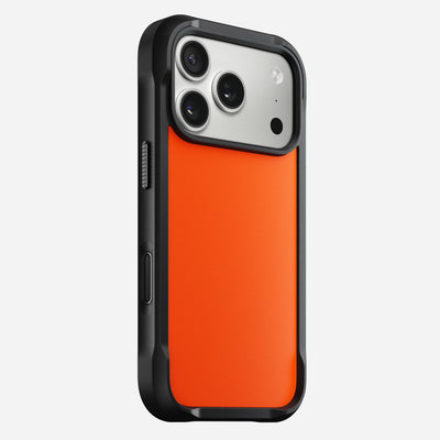 The Nomad Rugged Case - iPhone 17 Pro | Ultra Orange is shown from the back, displaying its black and orange design, TPU bumpers, triple camera cutout, side buttons, and strong drop protection.