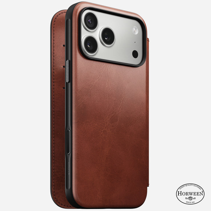 The Nomad Modern Leather Folio for iPhone 17 Pro Max in Olde Dublin is a brown Horween leather case with a fold-over cover, MagSafe compatible, showing the rear camera and side buttons, and featuring the Horween logo for premium quality.