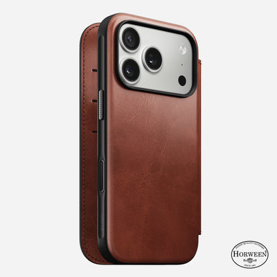 Nomad’s Modern Leather Folio in Olde Dublin for iPhone 17 Pro features premium brown Horween leather, a closeable cover, three camera lens cutouts, MagSafe compatibility, and the Horween logo on the bottom right.