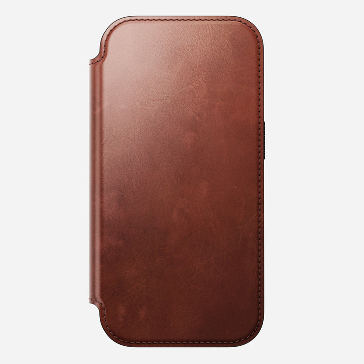The Nomad Modern Leather Folio for iPhone 17 Pro in Olde Dublin is a closed brown Horween leather case with visible edge stitching, shown vertically on a white background.