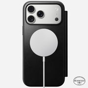 A Nomad Modern Leather Folio in black Horween leather is wirelessly charging an iPhone 17 Pro Max with three cameras; the Horween Leather Co. logo is visible at the bottom right of the case.