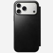 The Nomad Modern Leather Folio in Black (Horween) for iPhone 17 Pro Max is shown MagSafe compatible, displaying its triple camera setup through the back against a plain light background.
