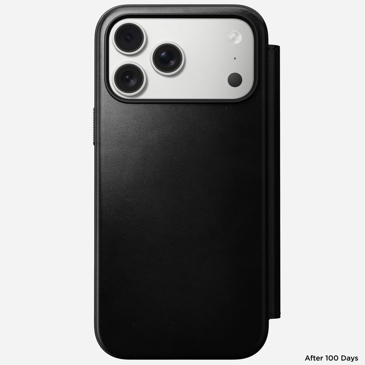 A Nomad Modern Leather Folio for iPhone 17 Pro Max in black Horween leather is displayed on a triple-camera phone against a plain white background, with "After 100 Days" shown at the bottom right.