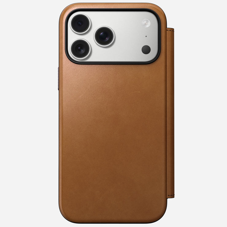 The Nomad Modern Leather Folio for iPhone 17 Pro Max in English Tan-C is a brown full-grain leather case with cover, shown from the back. Features camera cutout for three-lens, flash, and MagSafe compatibility for easy charging.