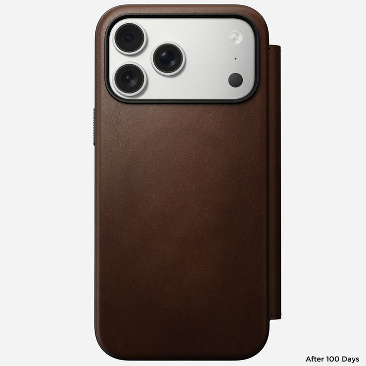A Nomad Modern Leather Folio in brown full-grain leather covers the iPhone 17 Pro Max, displaying its back camera module. "After 100 Days" is shown in the bottom right corner.